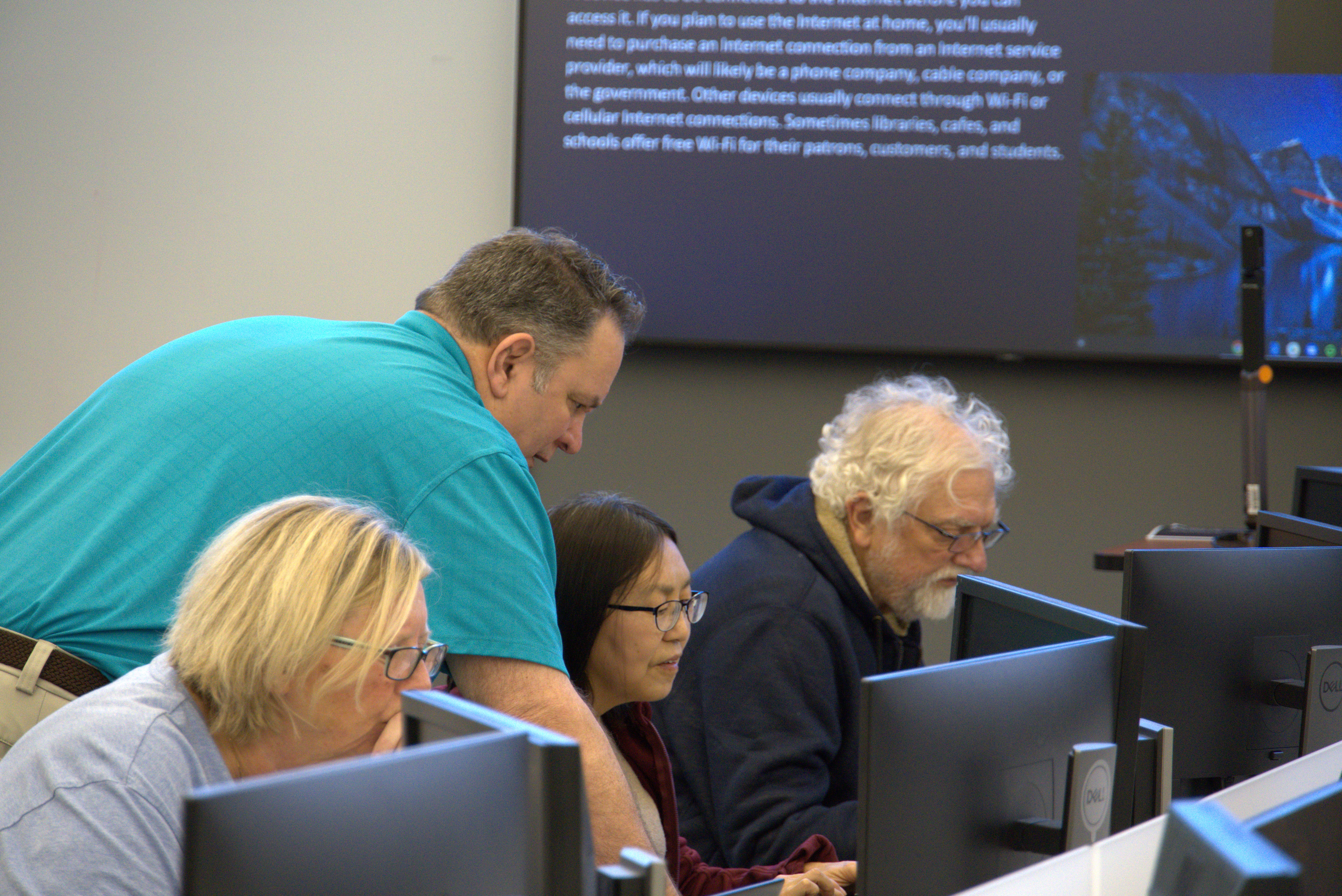 Technologies Coordinator Ray Acker helps Kingsport Senior Center participants get their laptops set up for a class about online safety and cyber awareness. The class will be taught each Friday this semester in the Technical Education Complex and cover password safety, phishing, malware, and scams.