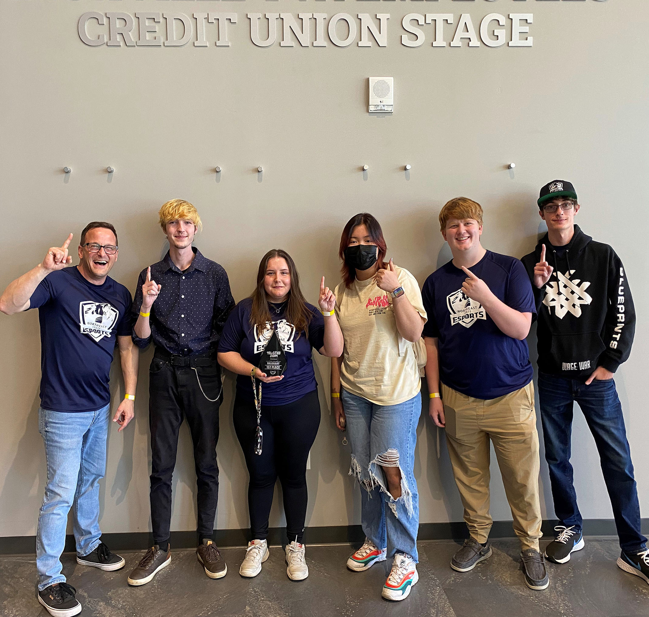 (From left to right) The Valorant team Coach Chris Demas, Alex Defreece, Haley Fields, Vy Nguyen, Mason Ramsey, and Ethan Fink with the tournament trophy.