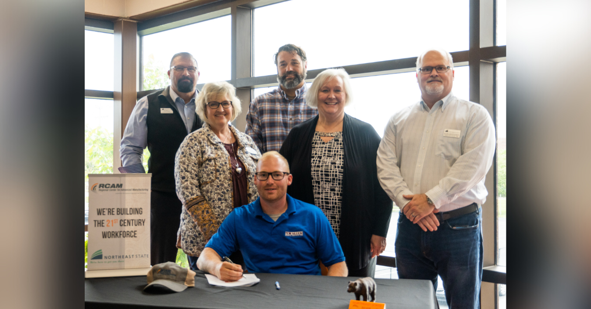Joshua Nelson commits to a one-year apprenticeship through J.A. Street. Pictured behind Nelson (from left to right) includes Greg Williams, Christy Parks, Marcus Wilcox, Cindy Necessary, and Blake Montgomery.